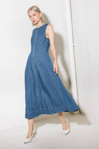 A washed denim midi dress featuring round neckline, sleeveless and front zipper closure.