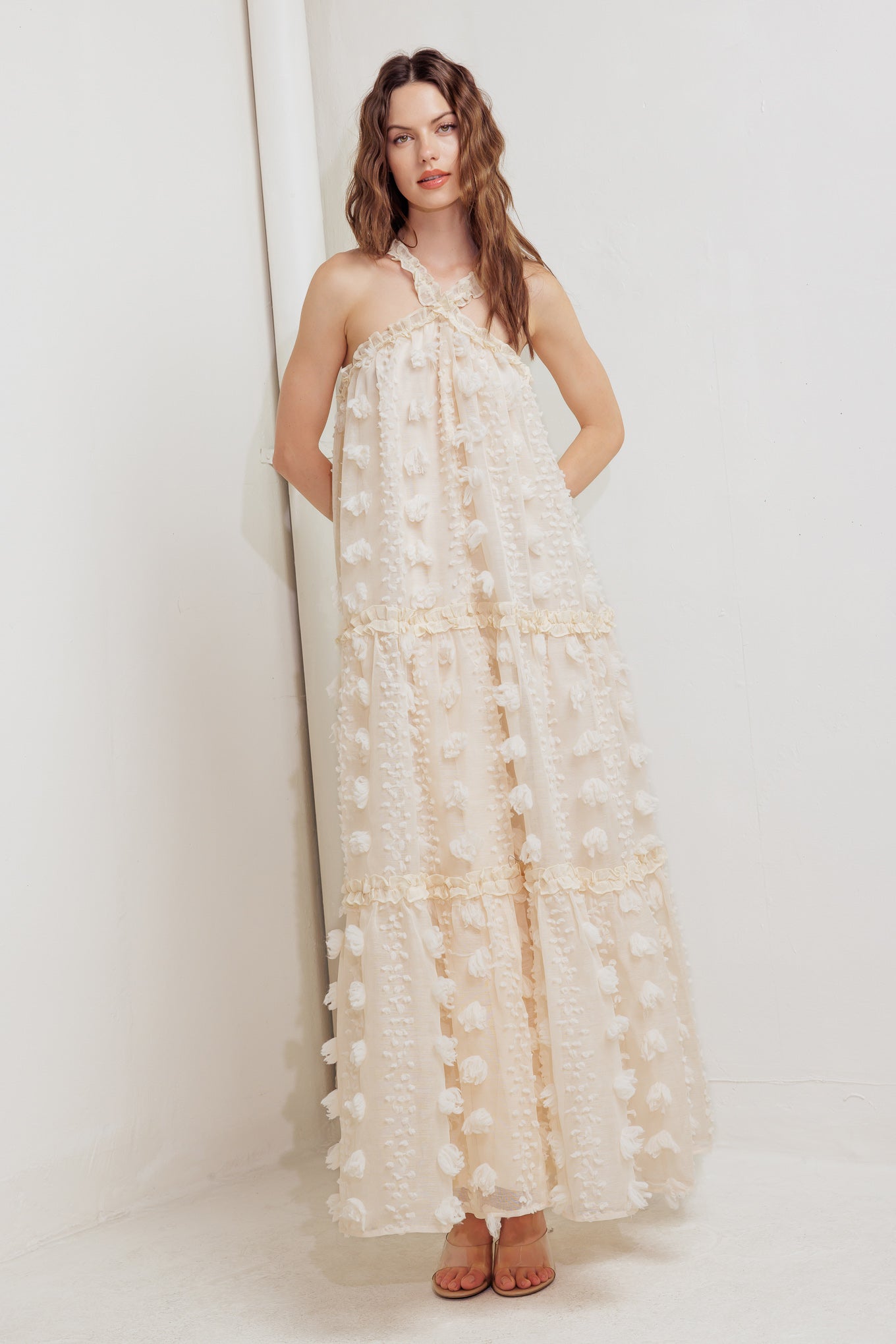 A cream textured woven ankle dress featuring ruffled cross front and tiered skirt