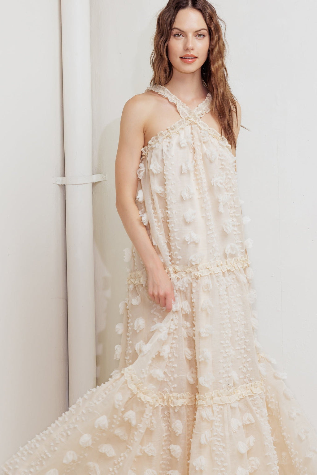 A cream textured woven ankle dress featuring ruffled cross front and tiered skirt
