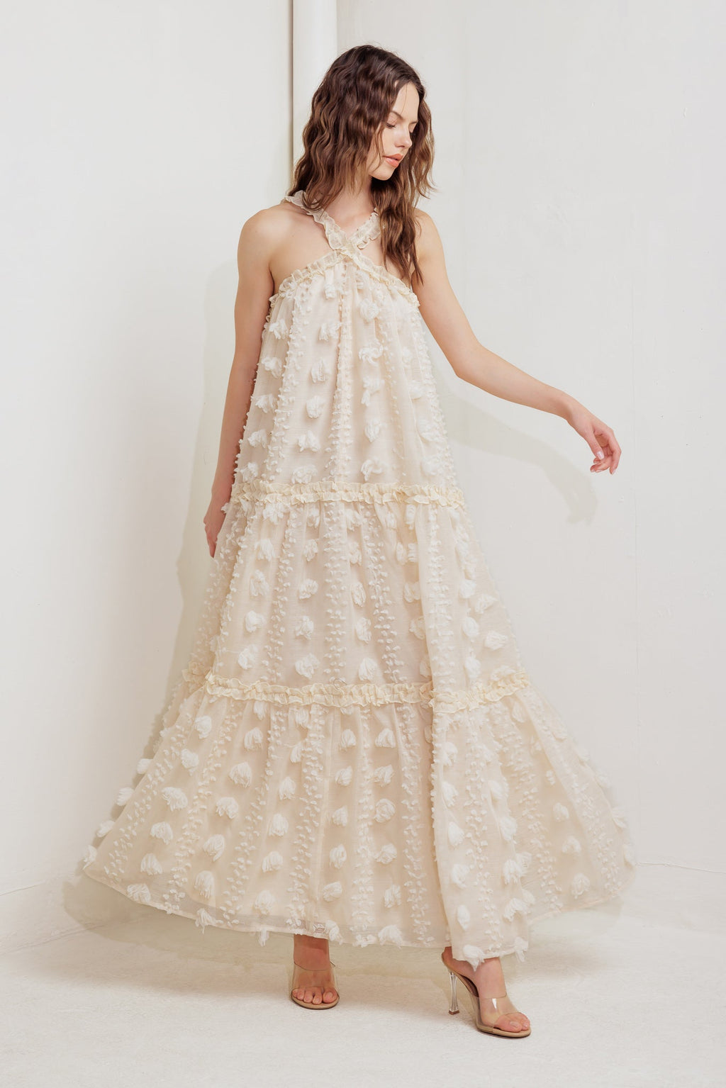 A cream textured woven ankle dress featuring ruffled cross front and tiered skirt