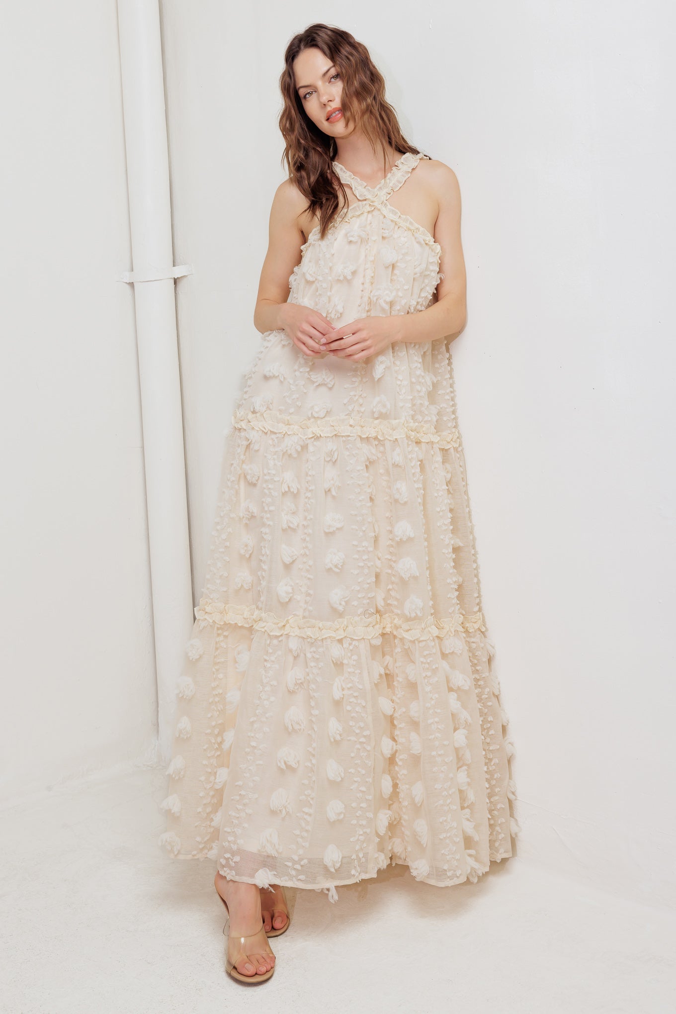 A cream textured woven ankle dress featuring ruffled cross front and tiered skirt