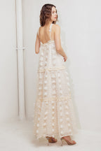 A cream textured woven ankle dress featuring ruffled cross front and tiered skirt