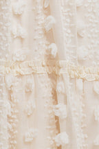 A cream textured woven ankle dress featuring ruffled cross front and tiered skirt