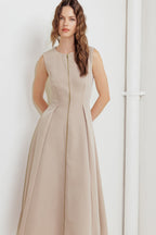 A solid woven midi dress featuring round neckline, sleeveless, front zipper closure and full skirt