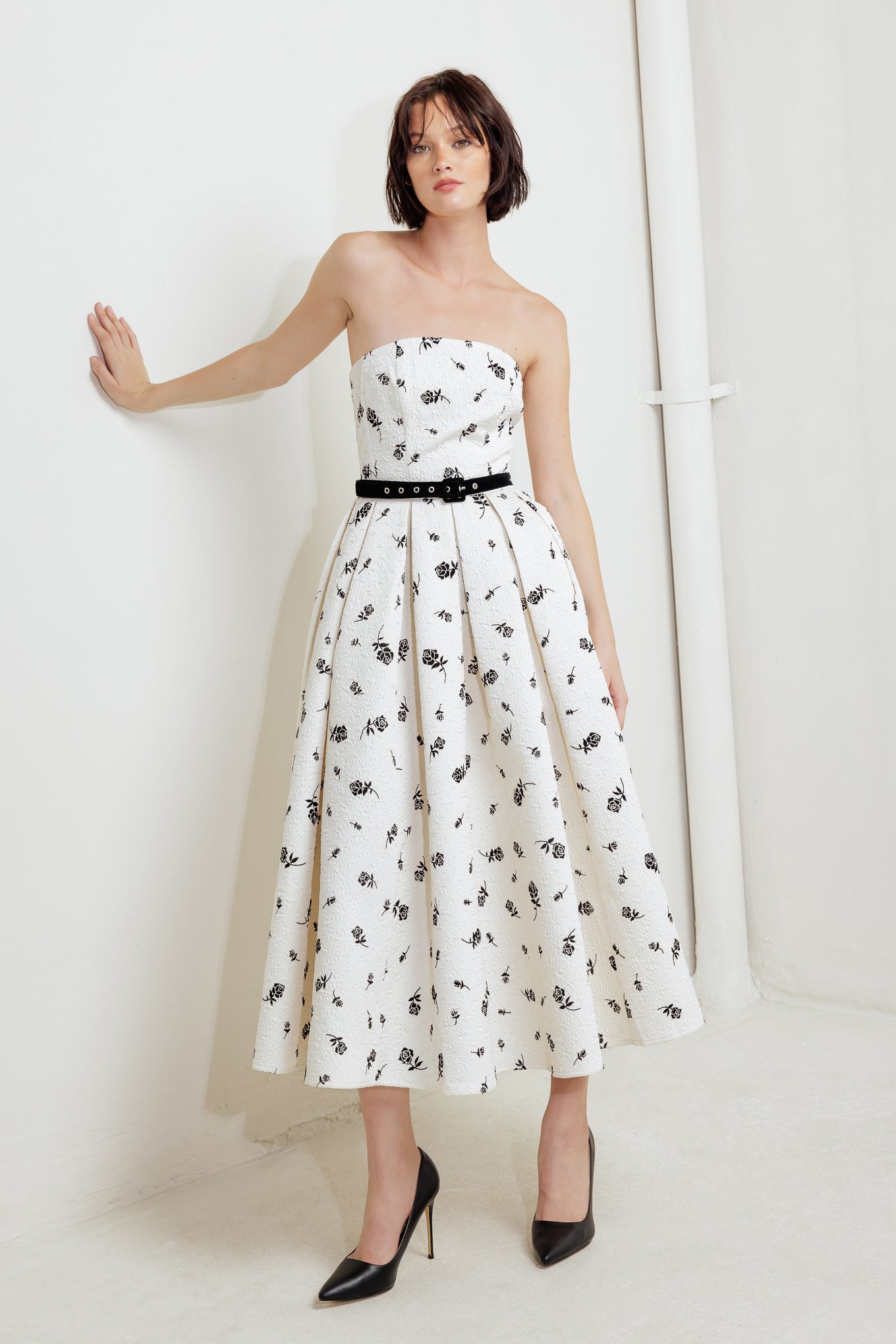 A printed textured woven midi dress featuring strapless neckline, contrasting belt, full skirt and back zipper closure