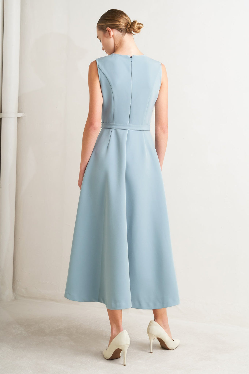 Solid soft blue midi dress with round neck, pintuck front & self-belt. Circle skirt, sleeveless.