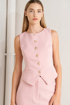 A solid pink woven vest featuring round neckline, sleeveless and front button-down closure