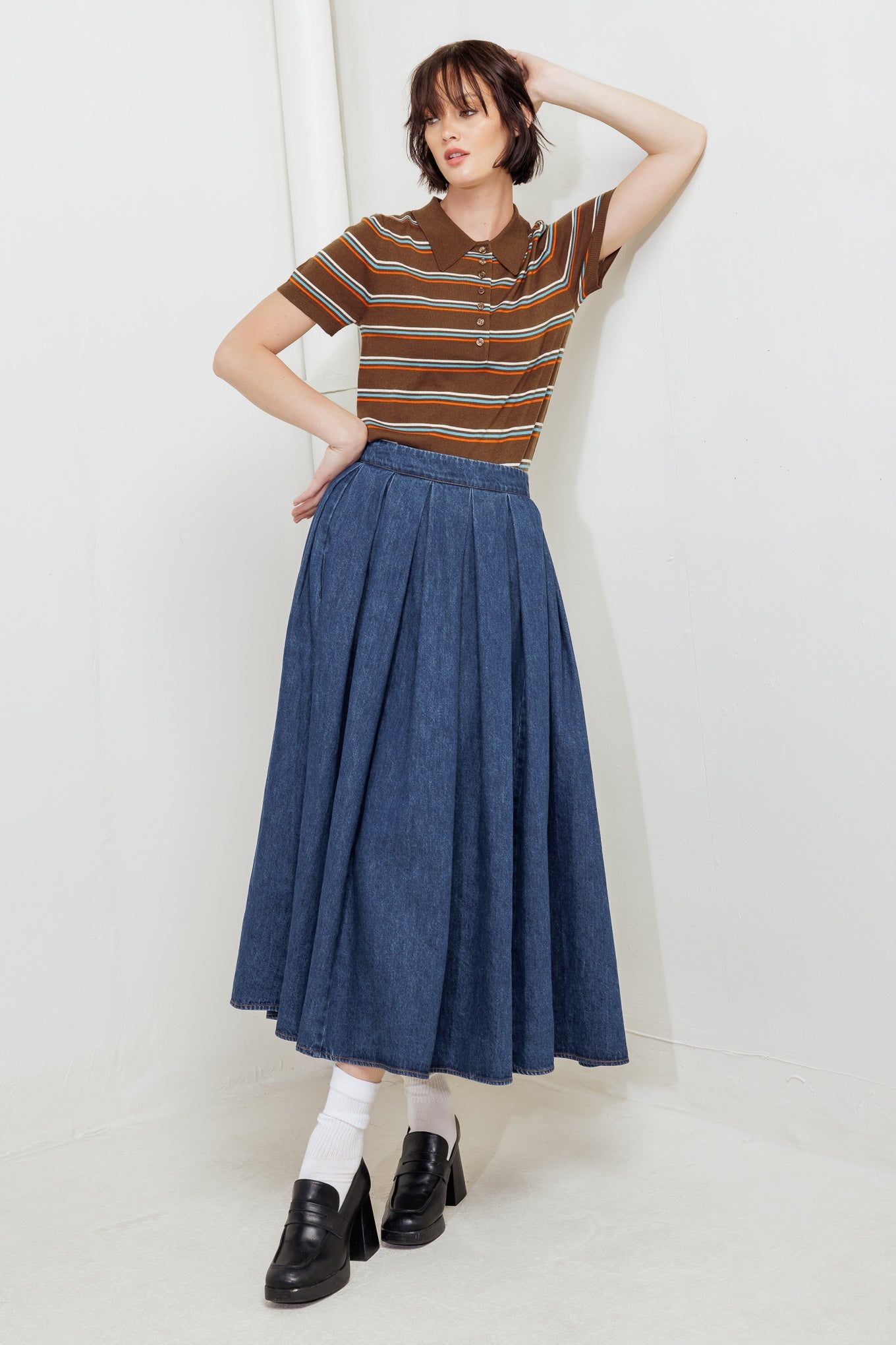 A washed denim full skirt with back zipper closure