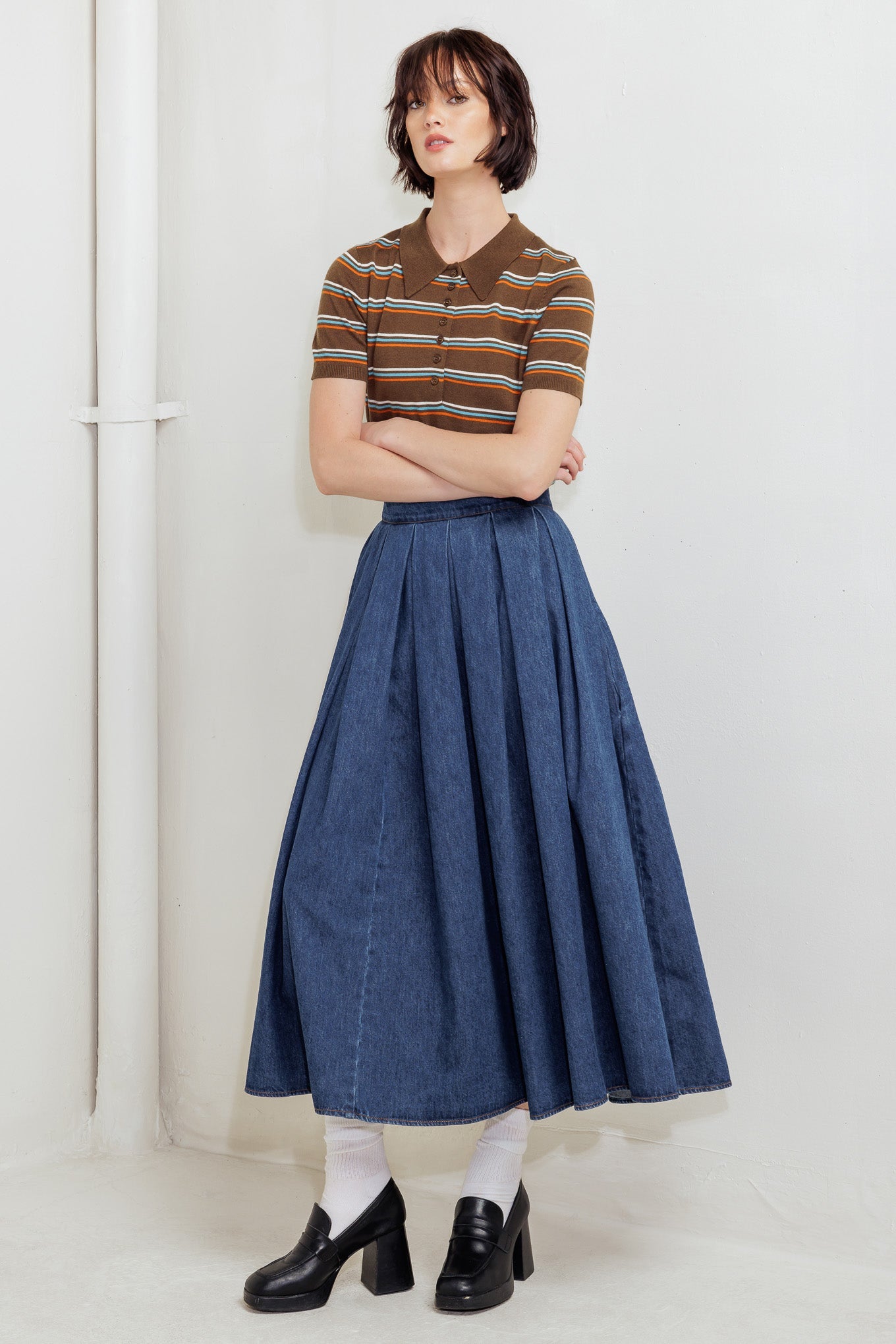 A washed denim full skirt with back zipper closure