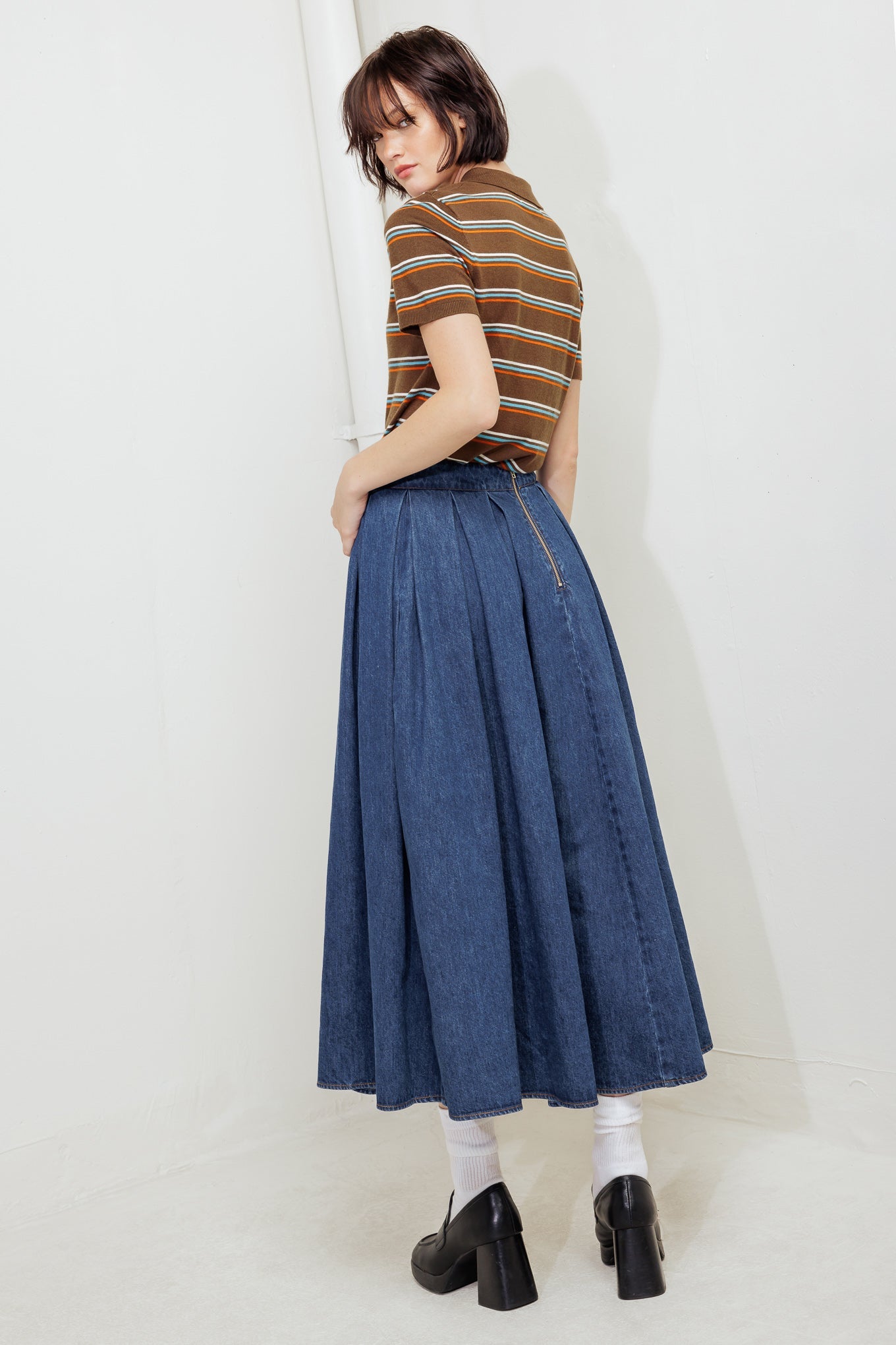 A washed denim full skirt with back zipper closure