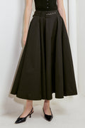 A solid black woven full midi skirt featuring self-belt and side zipper closure