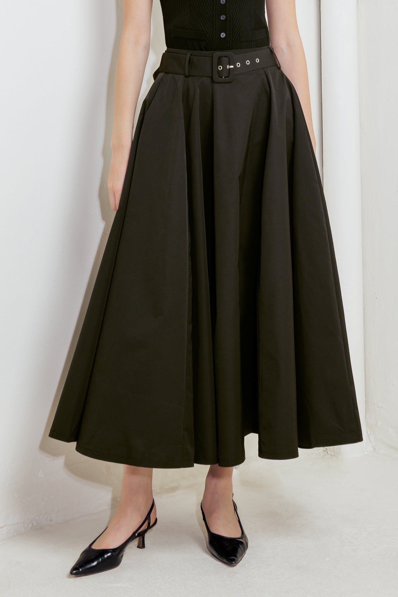A solid black woven full midi skirt featuring self-belt and side zipper closure