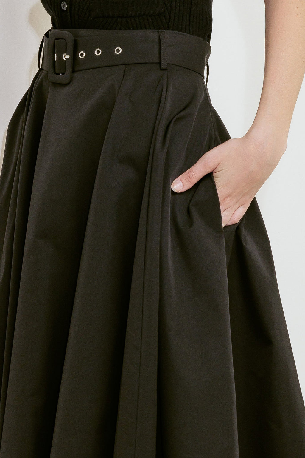 A solid black woven full midi skirt featuring self-belt and side zipper closure