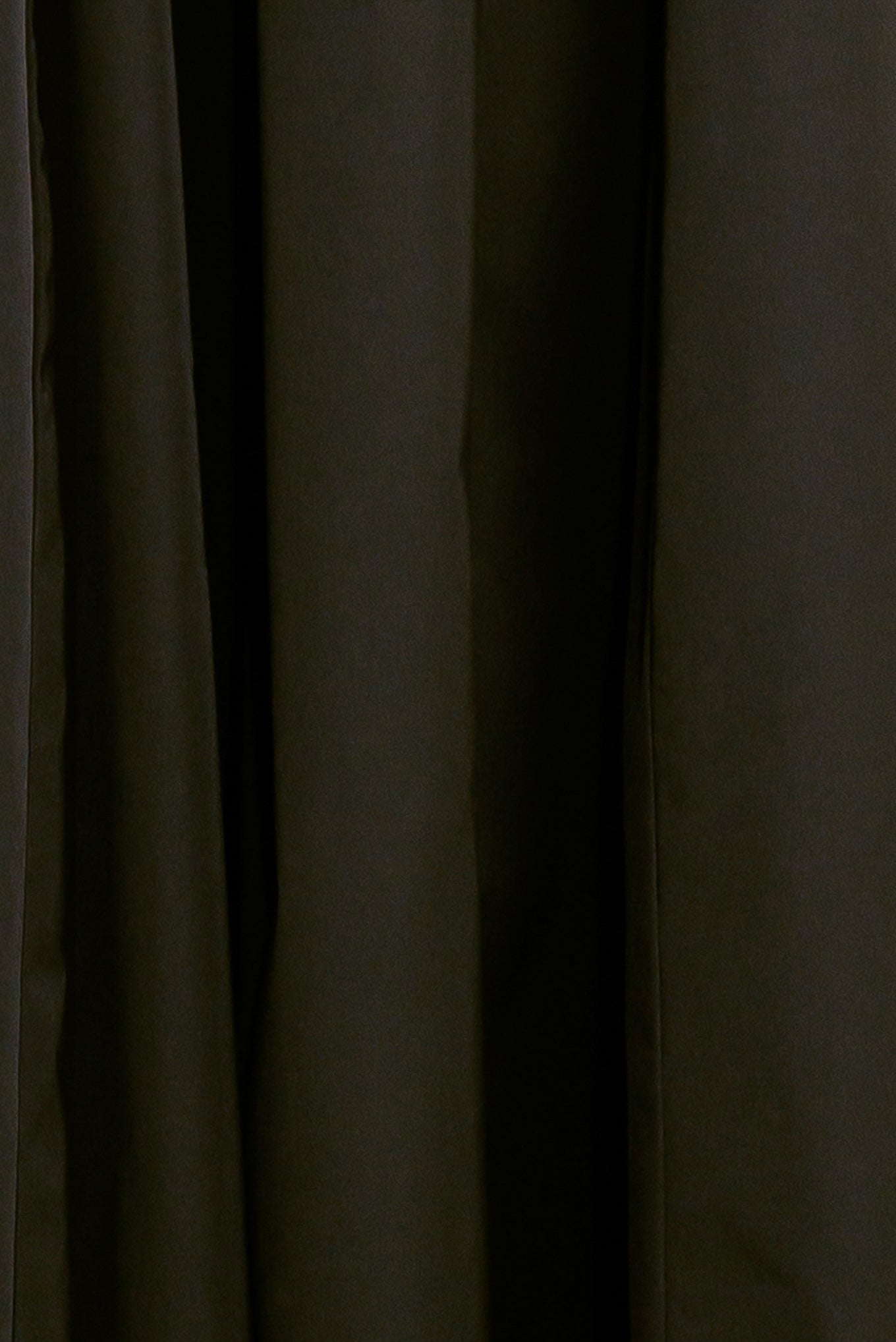 A solid black woven full midi skirt featuring self-belt and side zipper closure