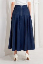 A solid navy woven pleated midi skirt with back zipper.
