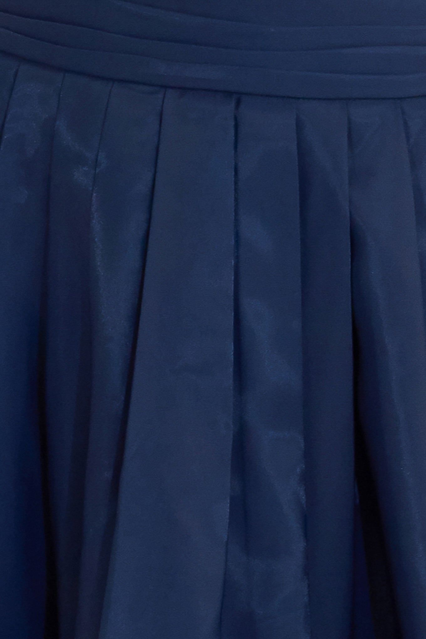 A solid navy woven pleated midi skirt with back zipper.