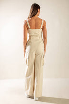 Solid oatmeal cotton jumpsuit with self-belt, cargo pockets, and front zipper. Versatile style, flattering fit.