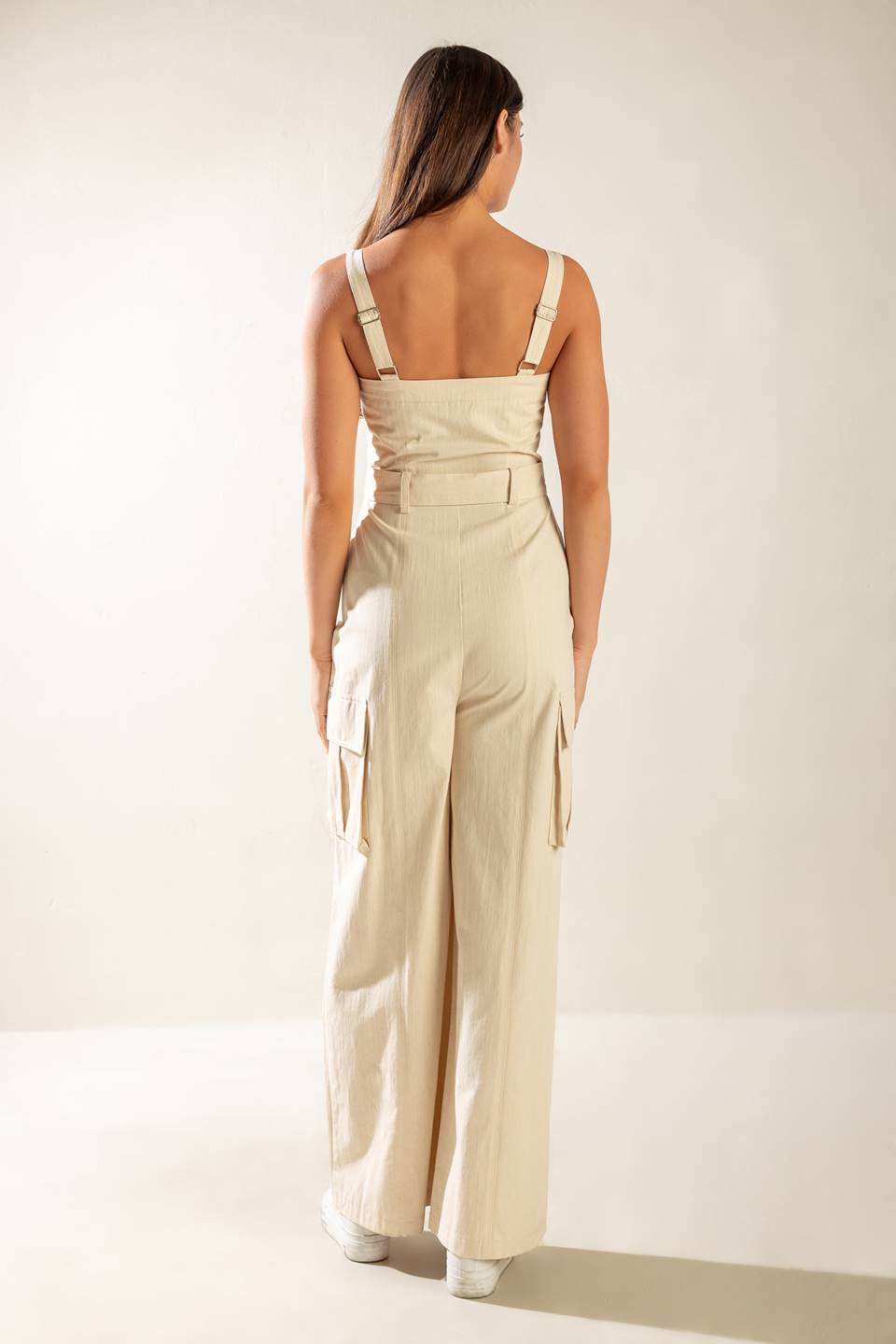 Solid oatmeal cotton jumpsuit with self-belt, cargo pockets, and front zipper. Versatile style, flattering fit.