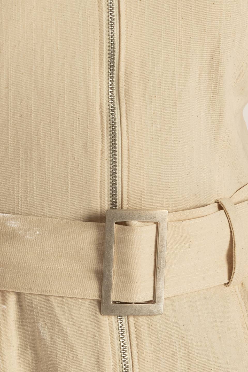 Solid oatmeal cotton jumpsuit with self-belt, cargo pockets, and front zipper. Versatile style, flattering fit.