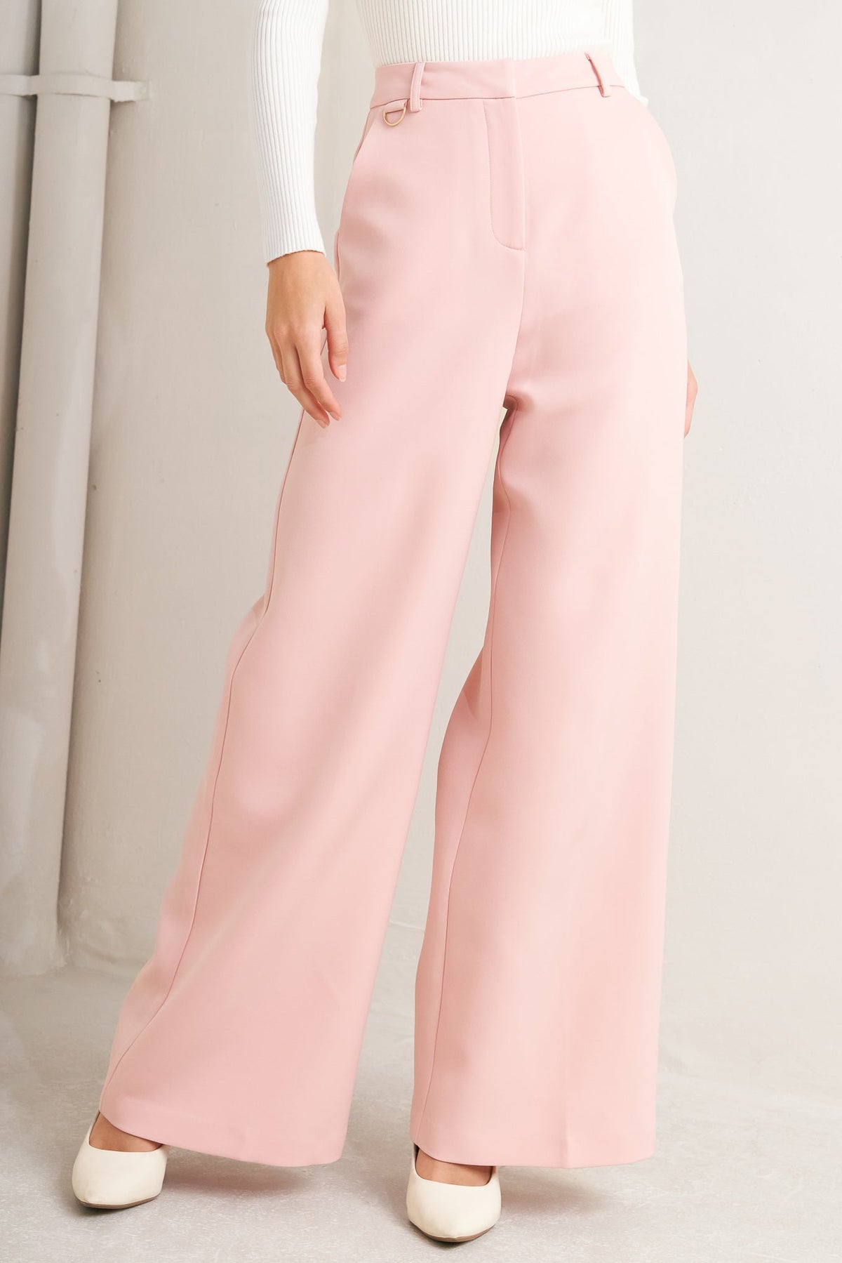 A solid pink woven pant featuring front closure, pockets and wide leg.