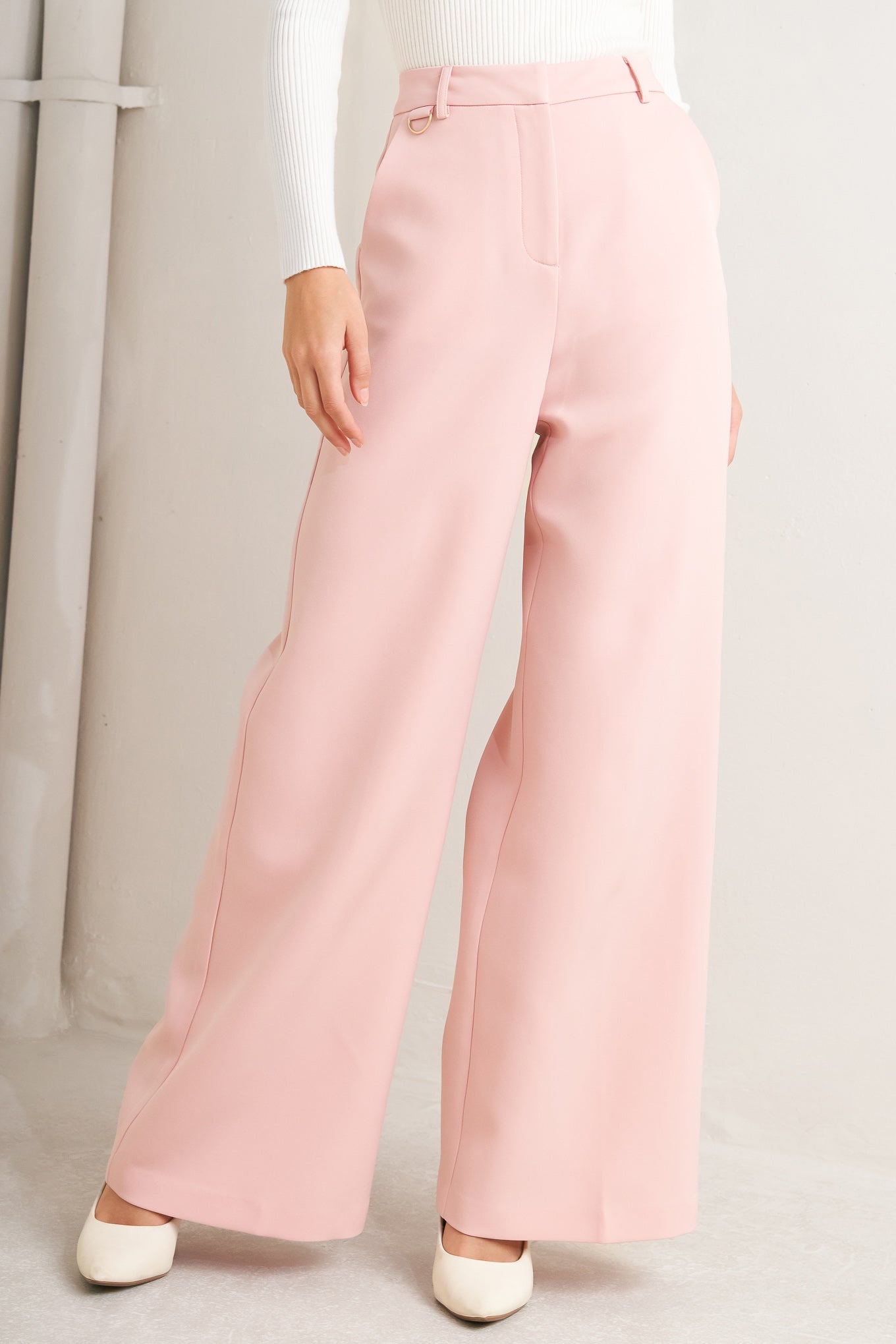 A solid pink woven pant featuring front closure, pockets and wide leg.