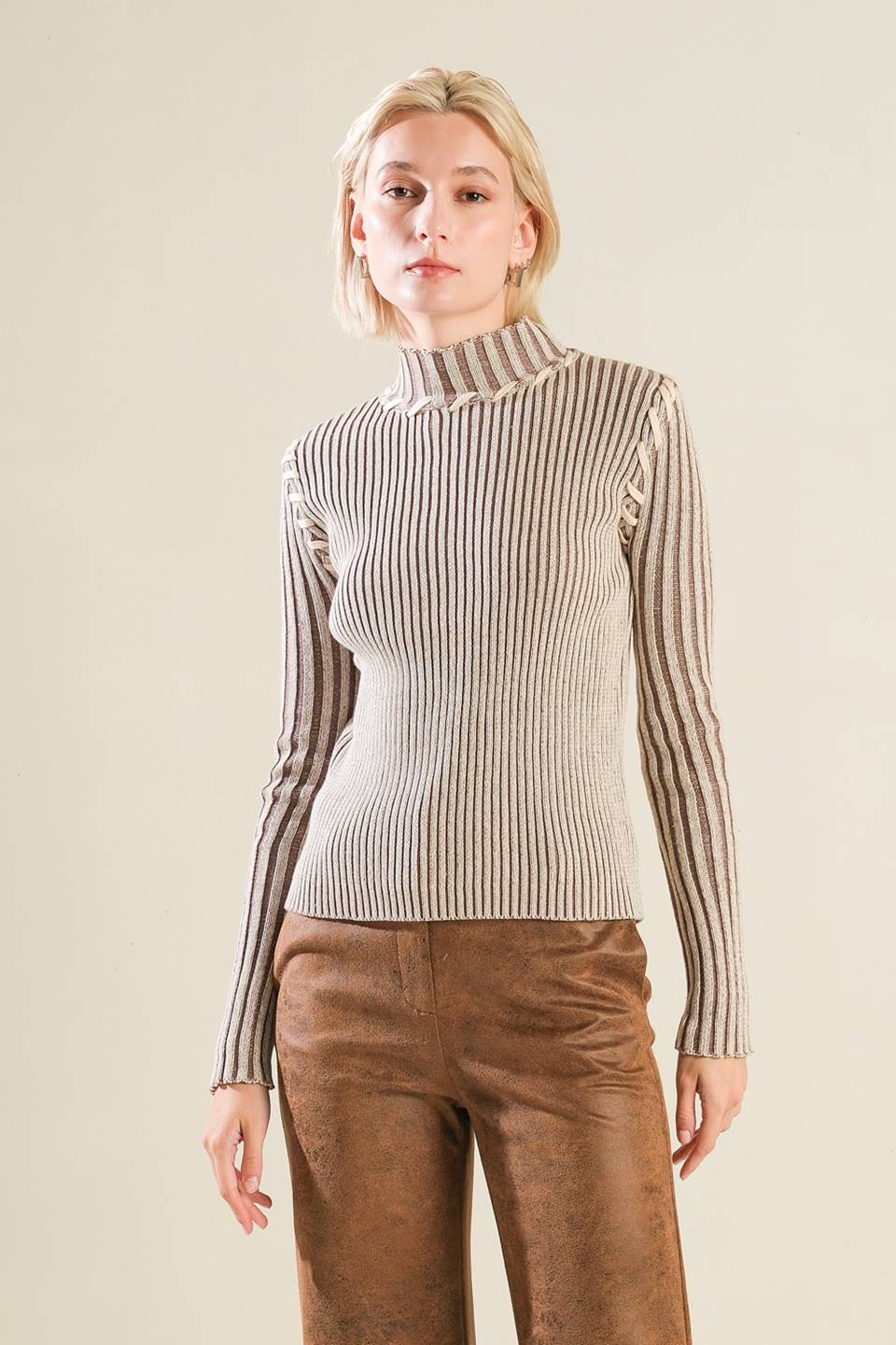 A ribbed sweater knit top with high neckline