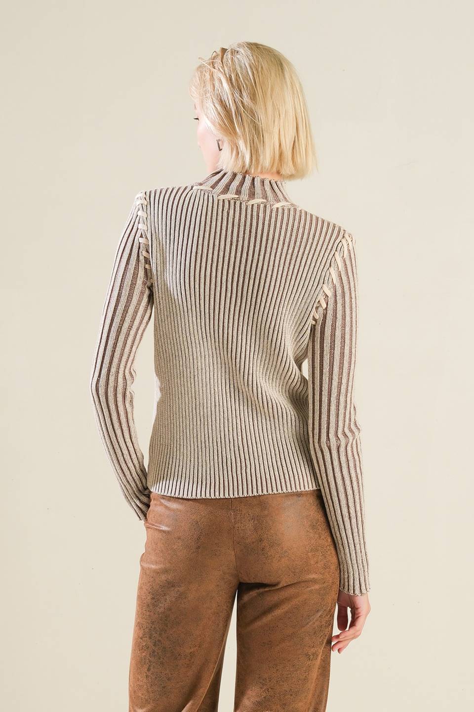 A ribbed sweater knit top with high neckline