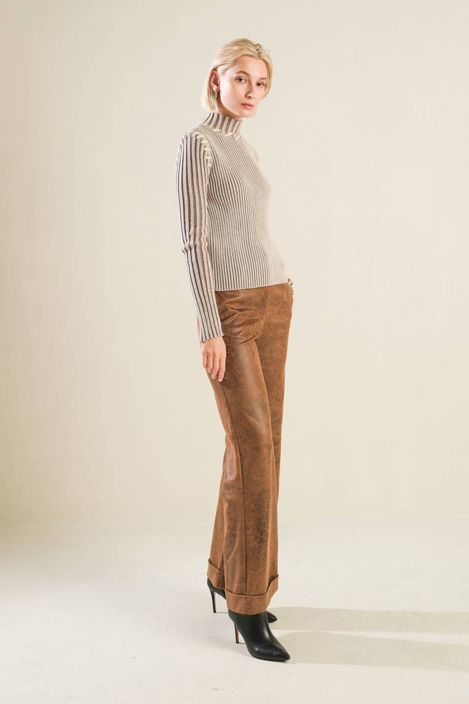 A ribbed sweater knit top with high neckline