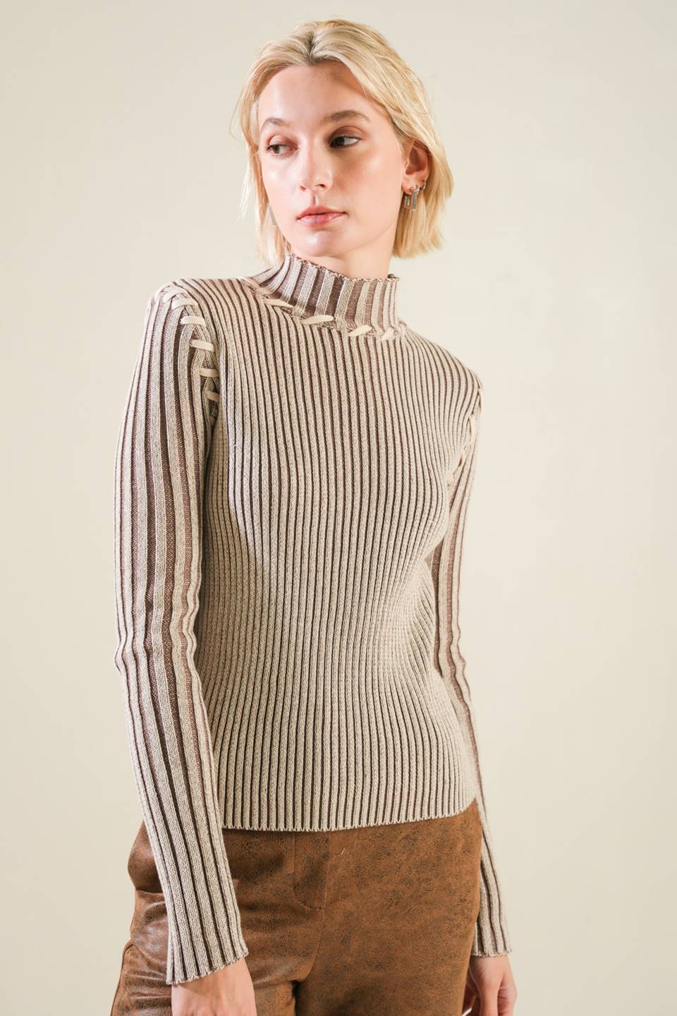 A ribbed sweater knit top with high neckline