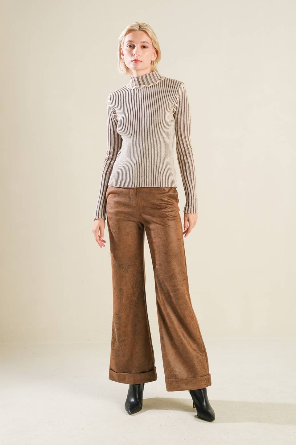 A ribbed sweater knit top with high neckline