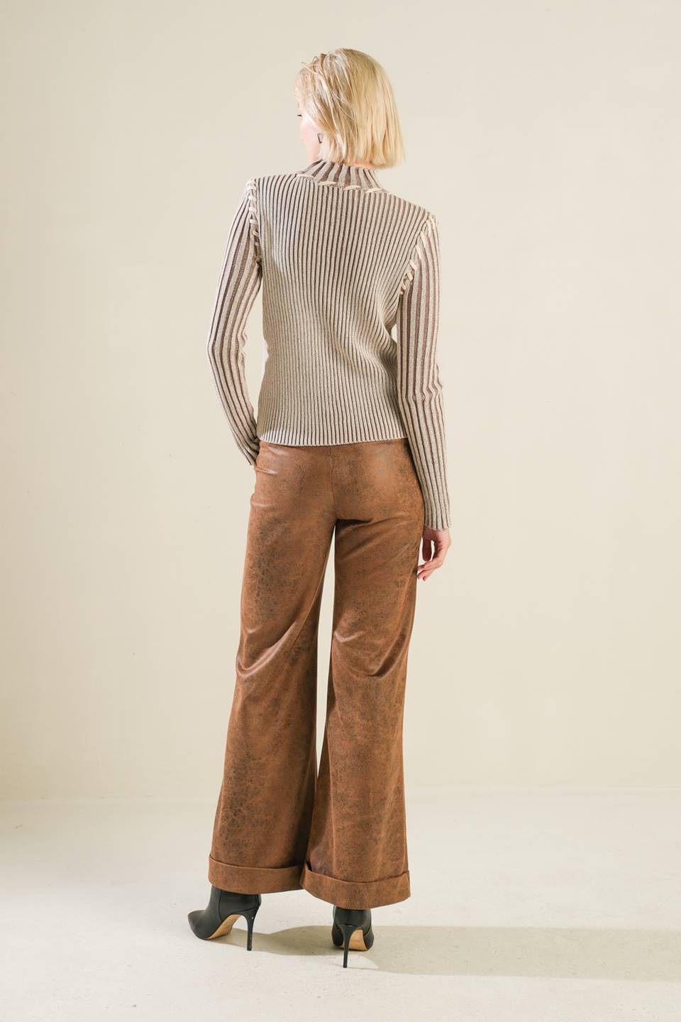 A ribbed sweater knit top with high neckline