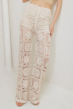 A crochet vest and pant set. Vest featuring front ties and elasticized waist pant