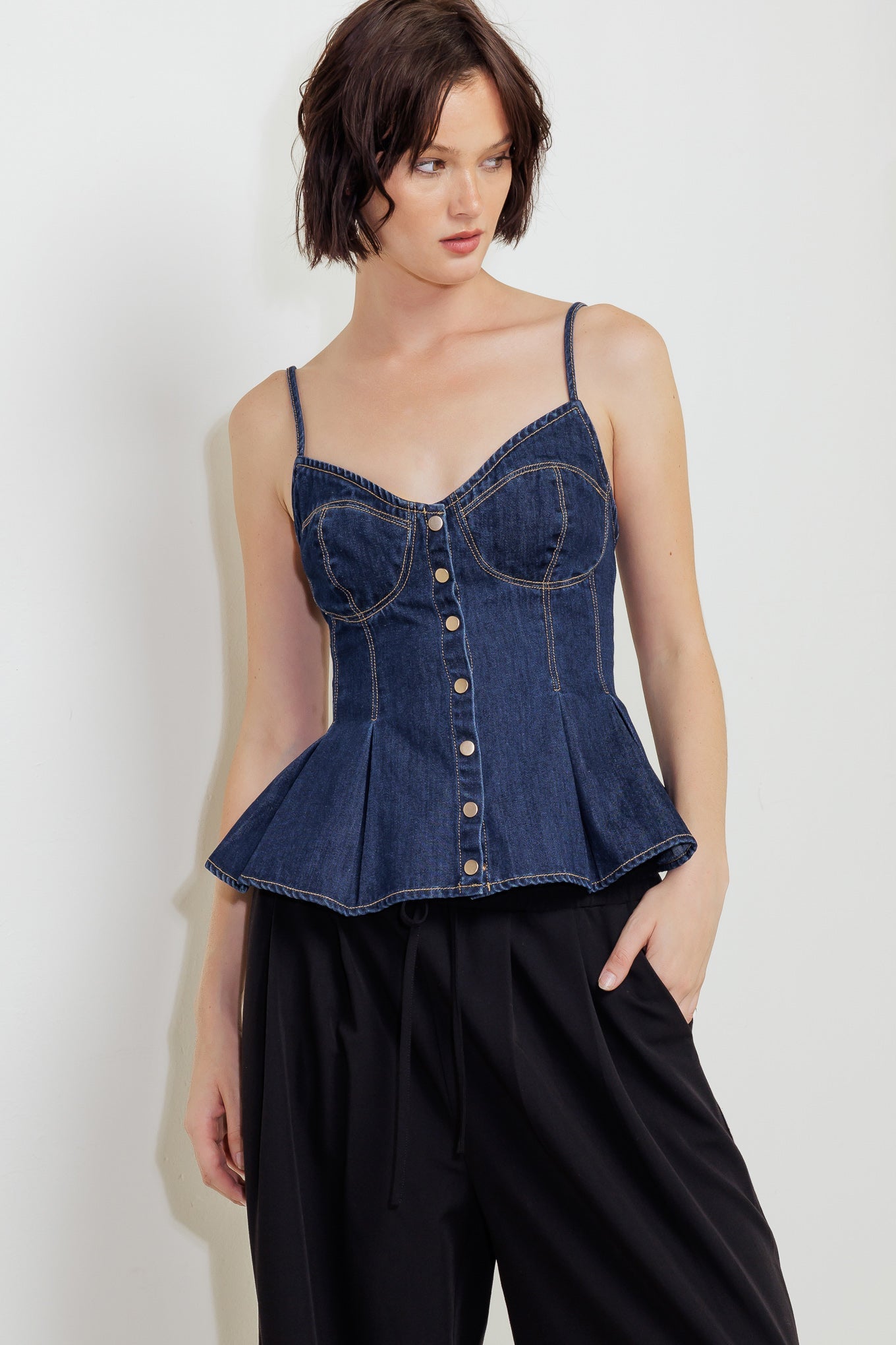 A lightweight denim cami top featuring front button down and peplum