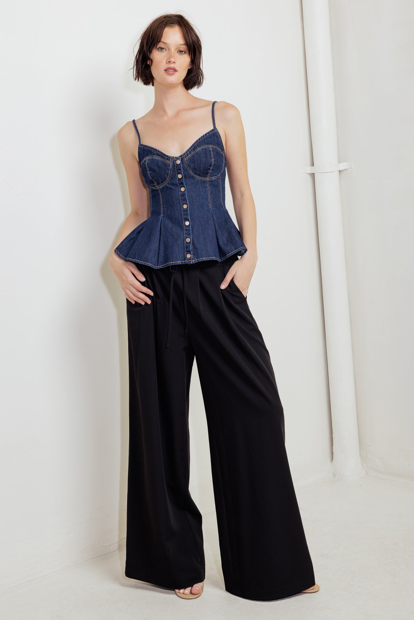 A lightweight denim cami top featuring front button down and peplum