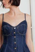 A lightweight denim cami top featuring front button down and peplum