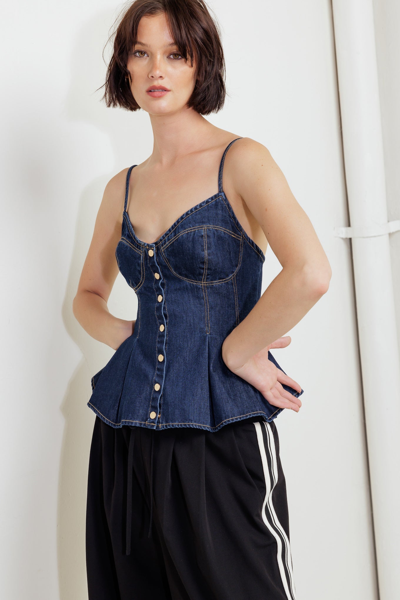 A lightweight denim cami top featuring front button down and peplum