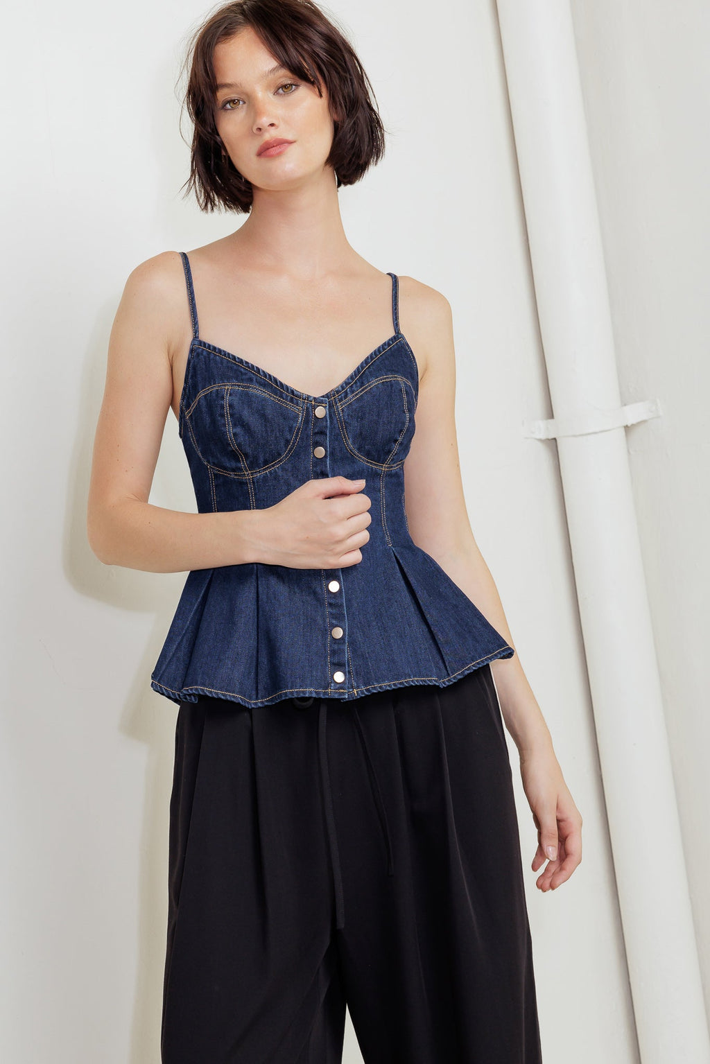 A lightweight denim cami top featuring front button down and peplum