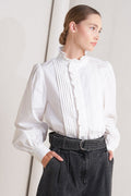 solid woven top featuring ruffled high neckline, long sleeve and front button down closure