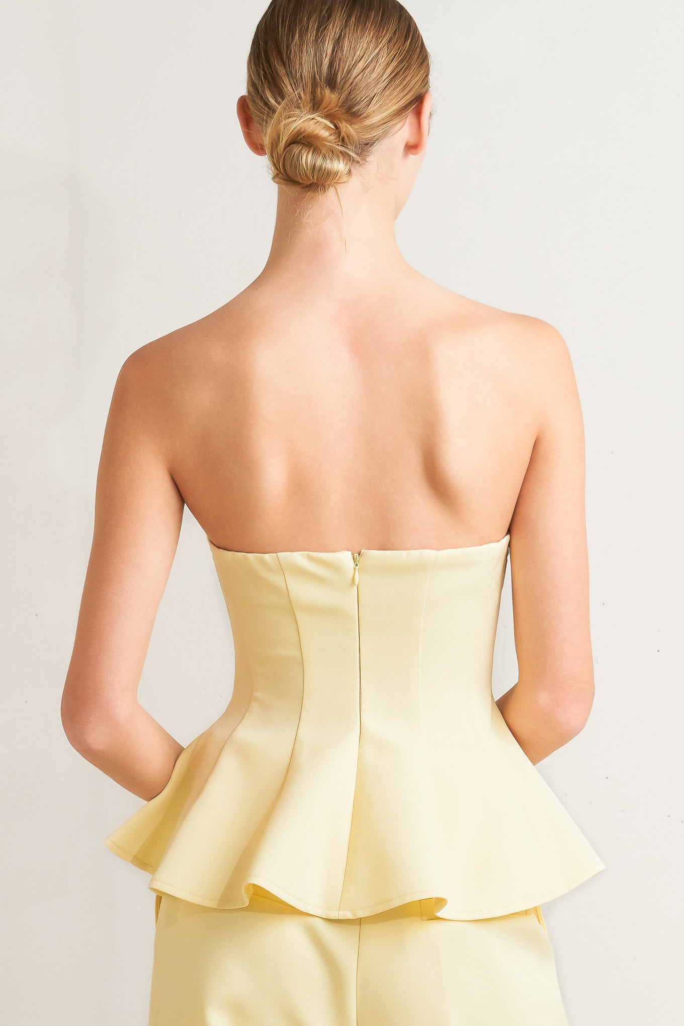 light yellow strapless peplum top