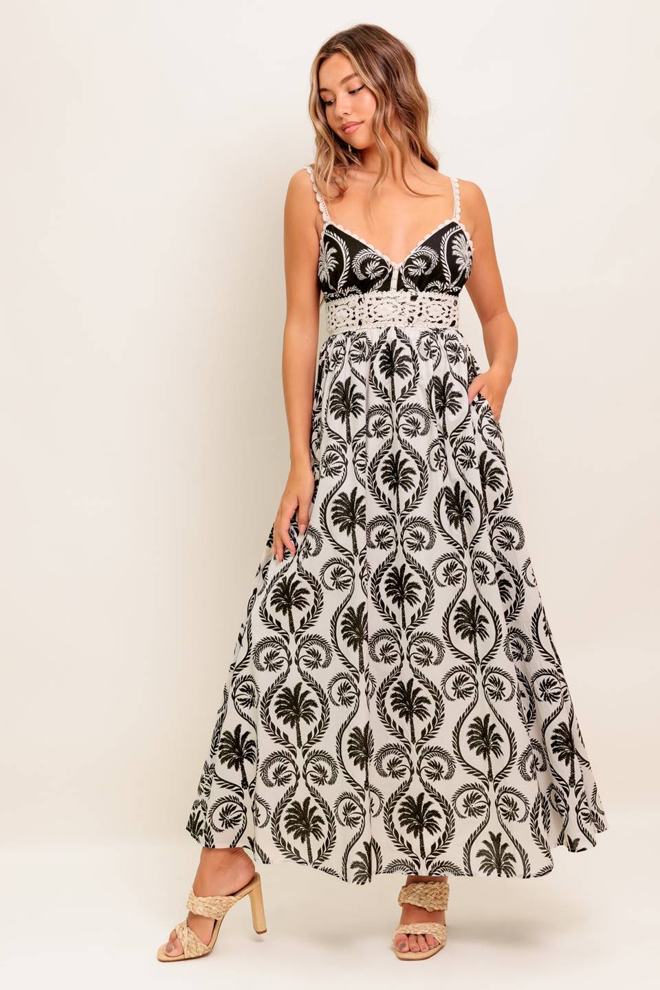 An Ivory & Black printed woven maxi dress featuring Cami top with crochet lace edge and waistband, full skirt and back zipper closure.