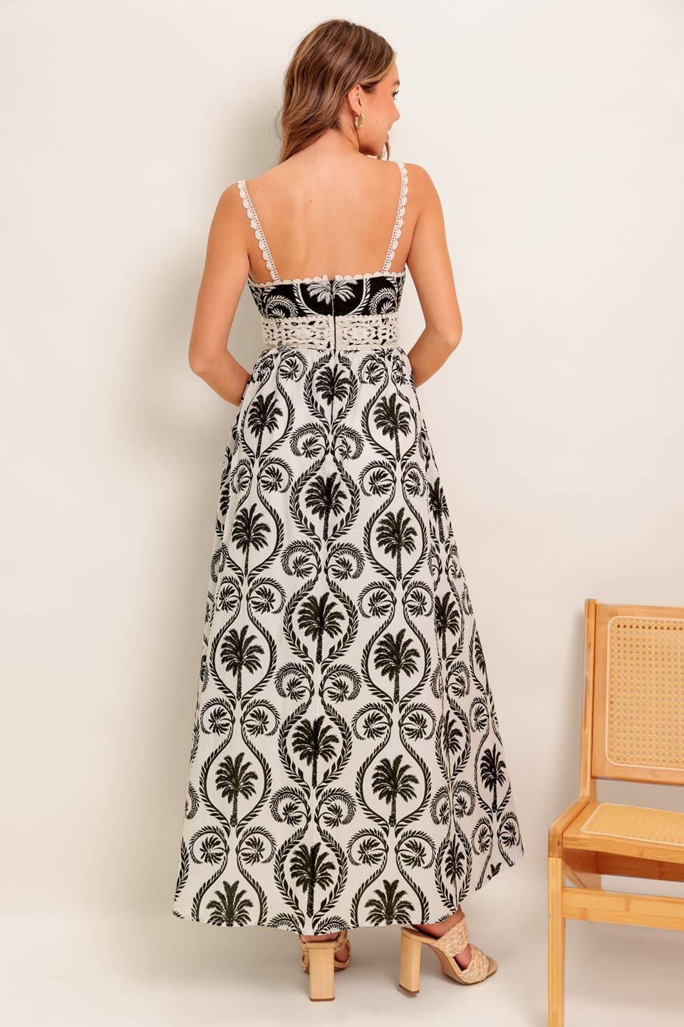 An Ivory & Black printed woven maxi dress featuring Cami top with crochet lace edge and waistband, full skirt and back zipper closure.