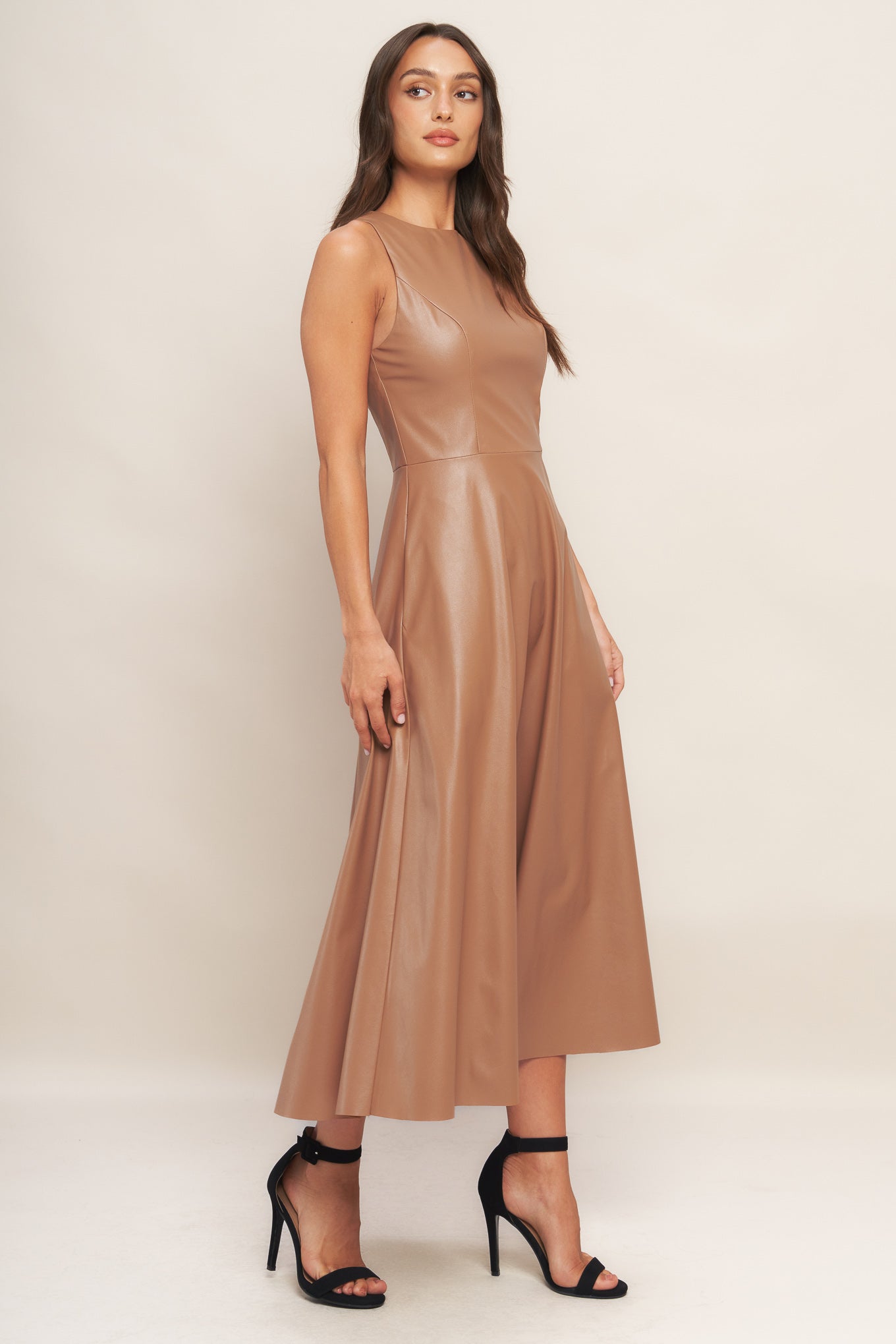 A faux leather midi dress featuring round neckline, sleeveless, circle skirt and back zipper closure