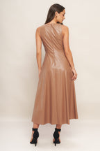 A faux leather midi dress featuring round neckline, sleeveless, circle skirt and back zipper closure