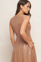 A faux leather midi dress featuring round neckline, sleeveless, circle skirt and back zipper closure