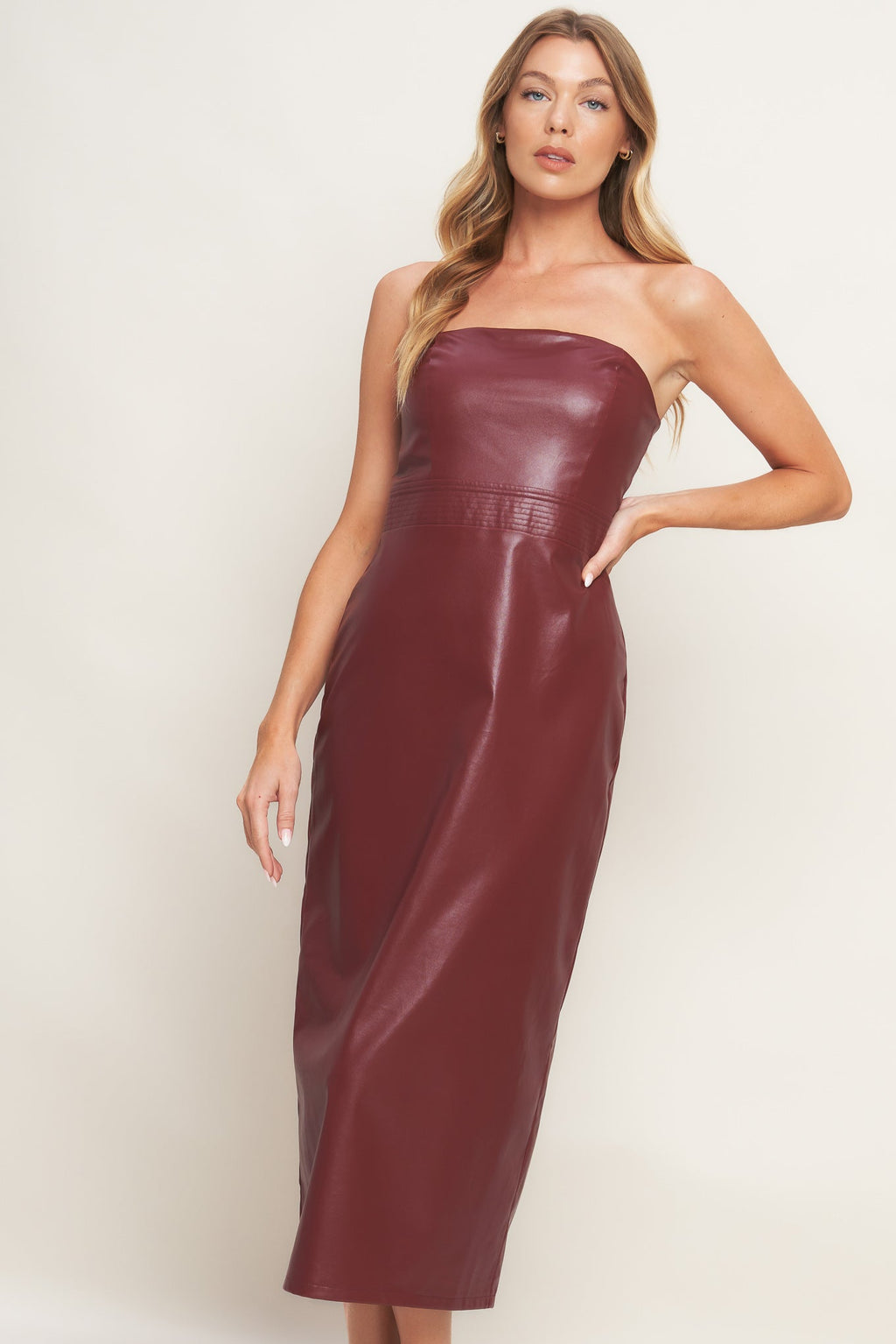 A burgundy faux leather midi dress featuring wide neckline, sleeveless, pencil skirt, back slit and back zipper closure