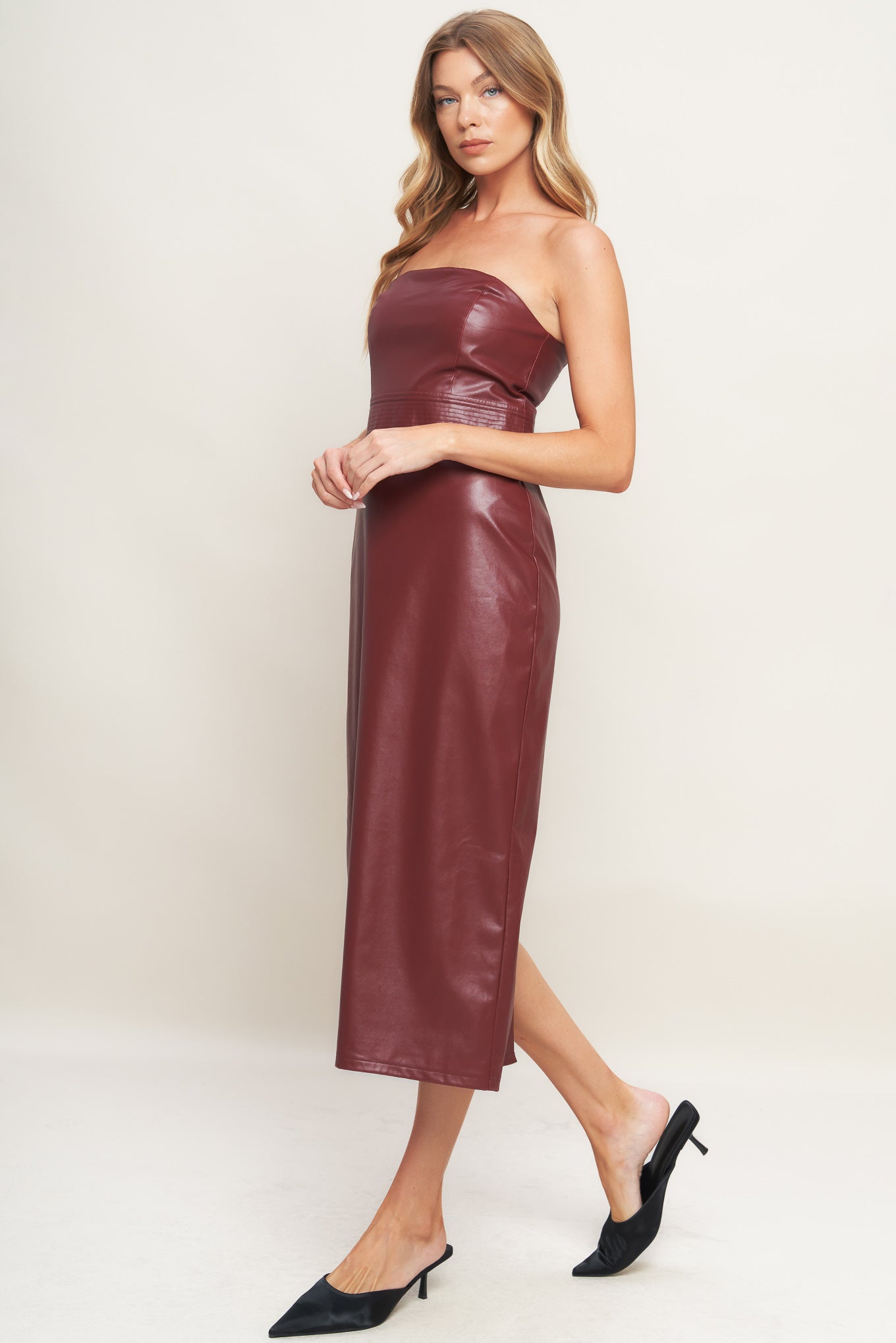 A burgundy faux leather midi dress featuring wide neckline, sleeveless, pencil skirt, back slit and back zipper closure