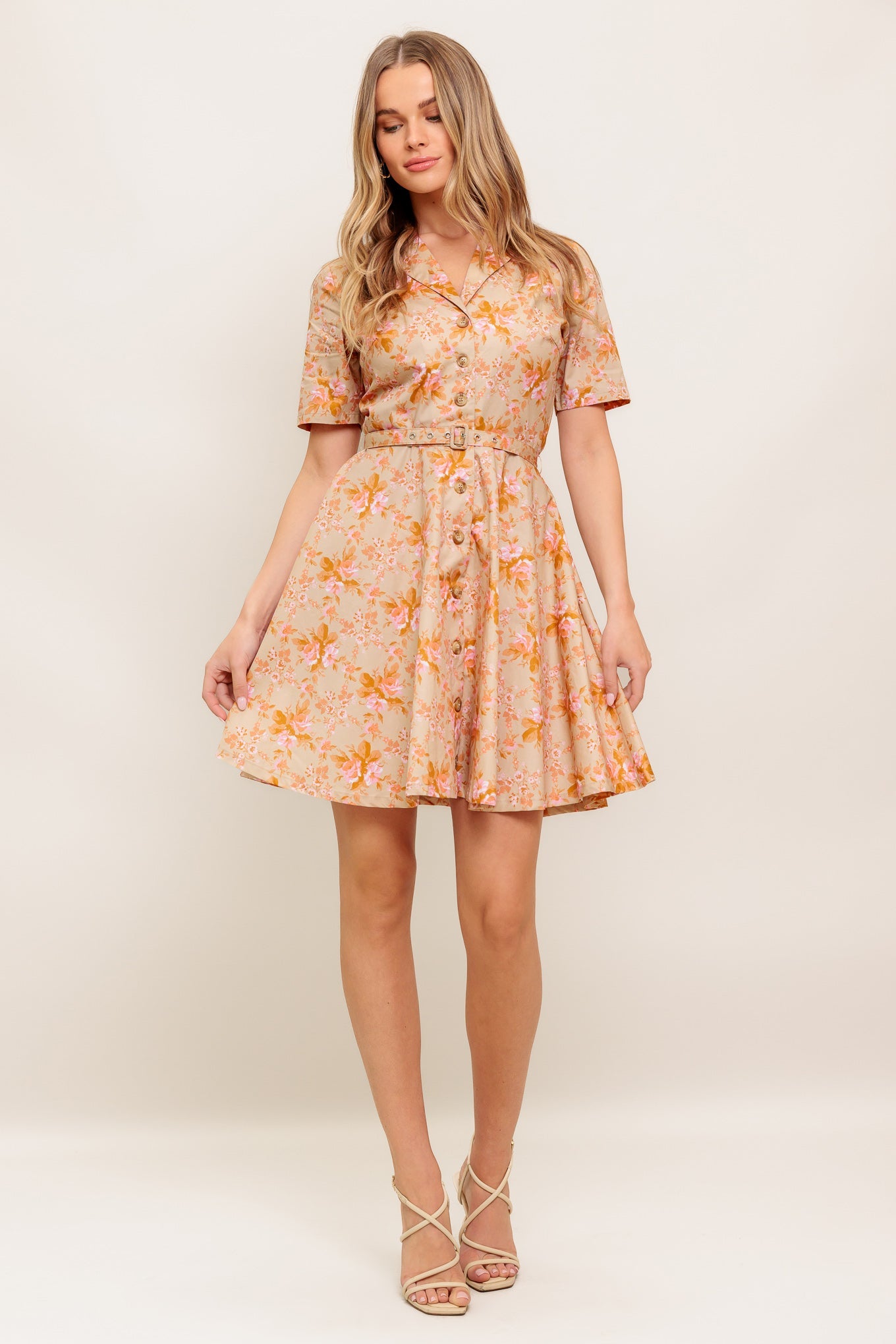 A printed woven mini dress featuring collar, button down, short sleeve, self-belt and circle skirt