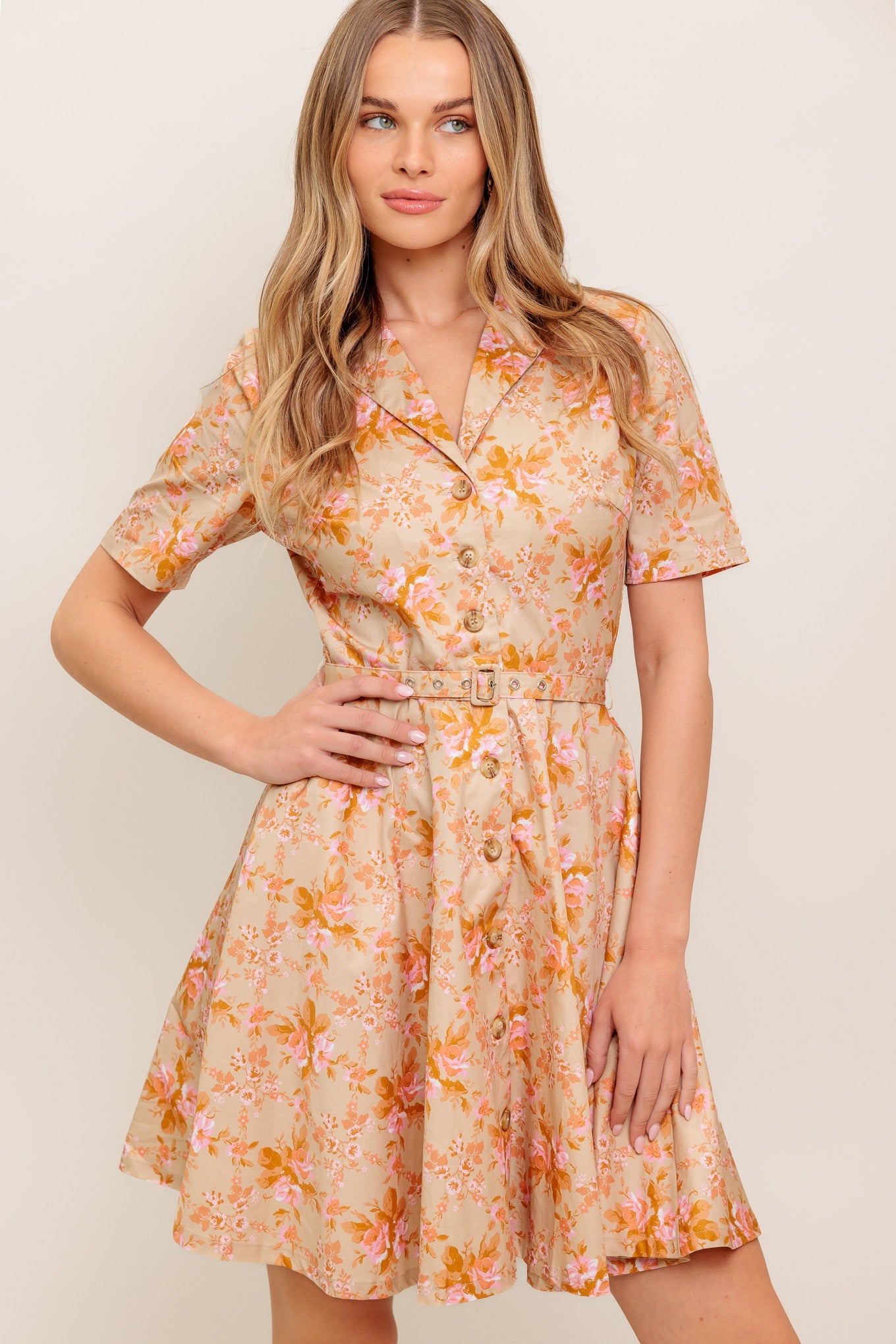 A printed woven mini dress featuring collar, button down, short sleeve, self-belt and circle skirt
