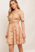 A printed woven mini dress featuring collar, button down, short sleeve, self-belt and circle skirt