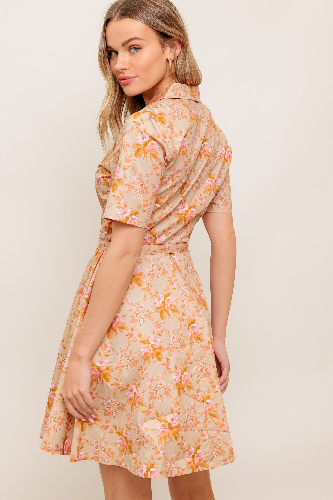 A printed woven mini dress featuring collar, button down, short sleeve, self-belt and circle skirt